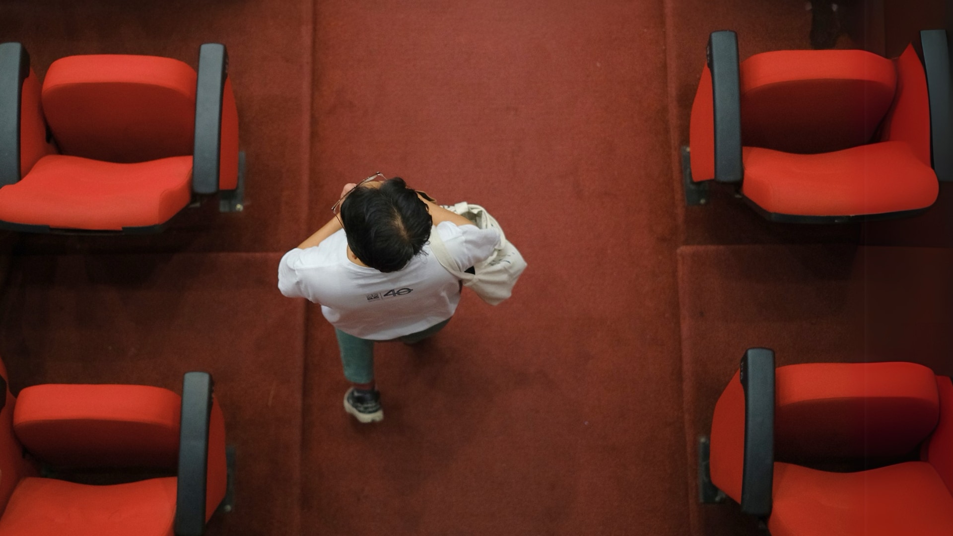 Person walking inside a theatre.
